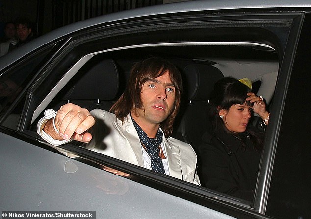 Liam Gallagher pictured with Lily Allen in a car leaving the Brit Awards afterparty in 2007