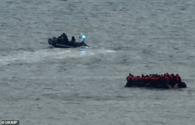 With flashing blue and red lights, the speedboat passed close to the dinghy several times, warning it to turn around and head for shore.