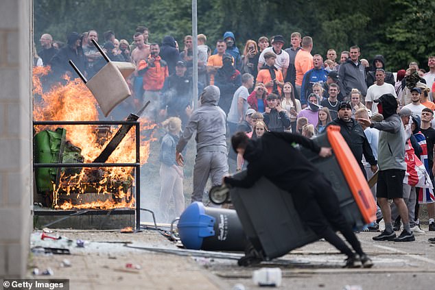 Anti-immigration protesters attempt to enter the Holiday Inn Express Hotel, which is housing asylum seekers, on August 4, 2024 in Rotherham