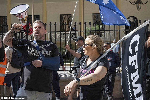 More than a thousand construction workers cheered and applauded former CFMEU NSW secretary Darren Greenfield as he spoke at the rally outside the state parliament on Tuesday (pictured protesters in Sydney)