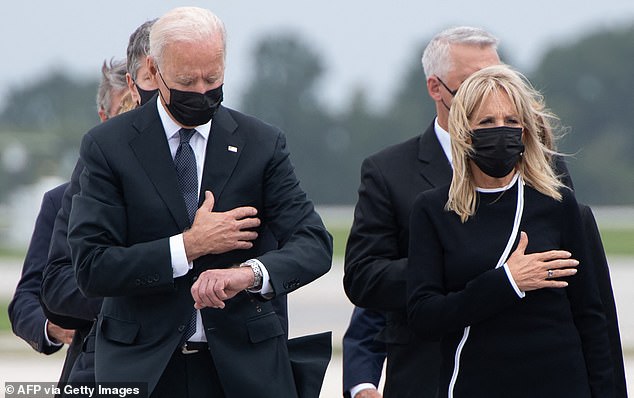 President Joe Biden looked at his watch as he and First Lady Jill Biden received the caskets of 13 U.S. service members who lost their lives in the failed troop withdrawal from Afghanistan in August 2021.