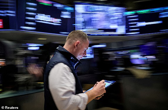 ARCHIVE PHOTO: A trader works on the floor of the New York Stock Exchange (NYSE) in New York City, U.S., March 7, 2024. REUTERS/Brendan McDermid/File Photo/File Photo