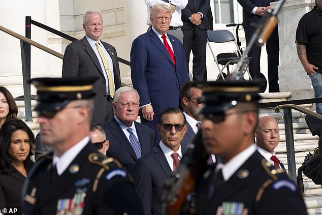 Bob Quackenbush, top left, deputy chief of staff at Arlington National Cemetery, and Donald Trump watch the changing of the guard at the Tomb of the Unknown Soldier at Arlington National Cemetery