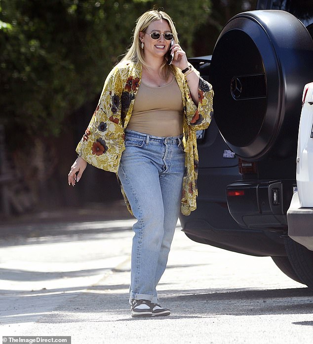 The actress, 36, showed off her slim postpartum figure wearing a nude tank top and a pair of high-waisted jeans with Nike sneakers