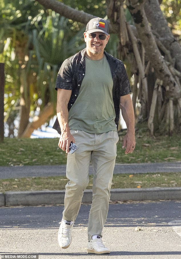 The 53-year-old Bourne star looked effortlessly stylish in an open, black patterned shirt, paired with a plain green T-shirt and beige trousers