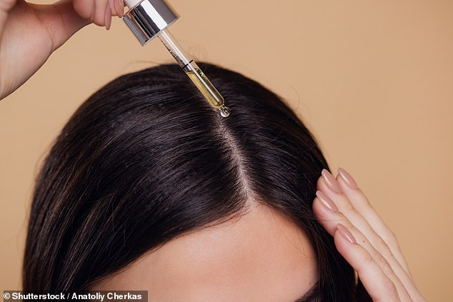 Researchers have discovered that chitosan, already popular in skin care, can also tame frizzy hair. Pictured is a woman applying hair serum