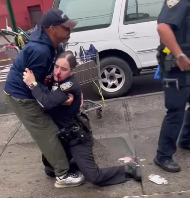 A female NYPD officer is left with a bloodied face after a repeat offender beat her in broad daylight, gruesome footage shows