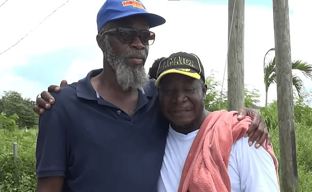 Jahmari's father, Michael Reid (right), was heartbroken on the beach when his son's remains were brought back to land