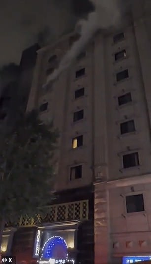 Photos show smoke billowing from an eighth-floor window where the fire is believed to have started