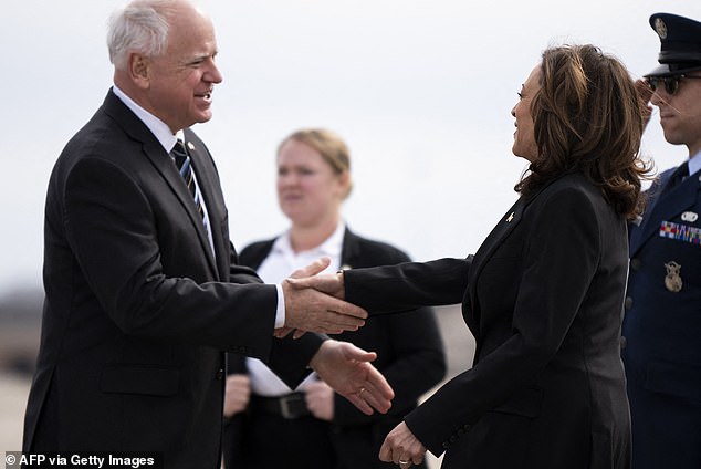 Minnesota Governor Tim Walz (left) greets Vice President Kamala Harris upon her arrival at Minneapolis-St. Paul International Airport