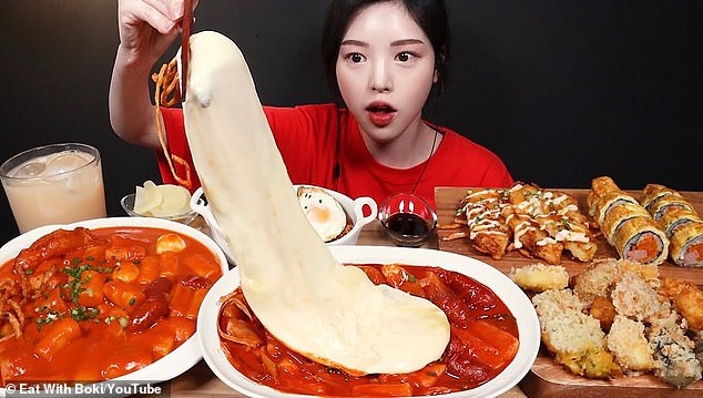 Boki, a young Korean YouTuber, indulges in a massive amount of food, also known as a mukbang challenge in front of a live audience