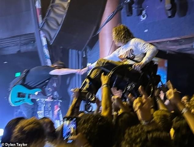 Disabled Australian heavy metal fan Dylan Taylor (pictured at a Polaris concert in San Diego) was humiliated after being turned away from a concert because he uses a wheelchair