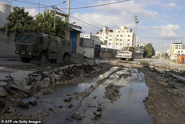 Israeli military vehicles drive on a road during a raid in the northern occupied West Bank town of Tulkarm