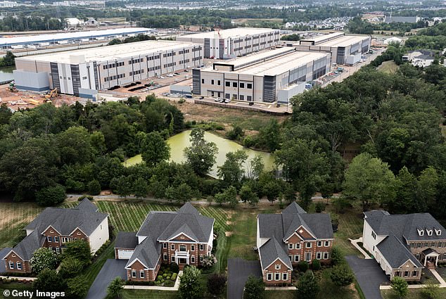 An Amazon Web Services data center is seen near single-family homes on July 17, 2024 in Stone Ridge, Virginia.