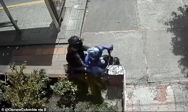 A suspect in a robbery (on a motorcycle) was brutally beaten by residents, while his accomplice (who was sitting behind the motorcyclist) managed to escape in Bogotá, Colombia on July 31, moments after crashing into the gate of a house