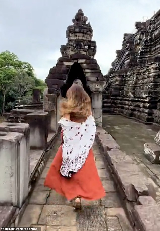 TikTok users including Chiara Contino (pictured) have filmed themselves running through Angkor Wat in Cambodia to take part in a viral trend called 'Temple Run in real life'