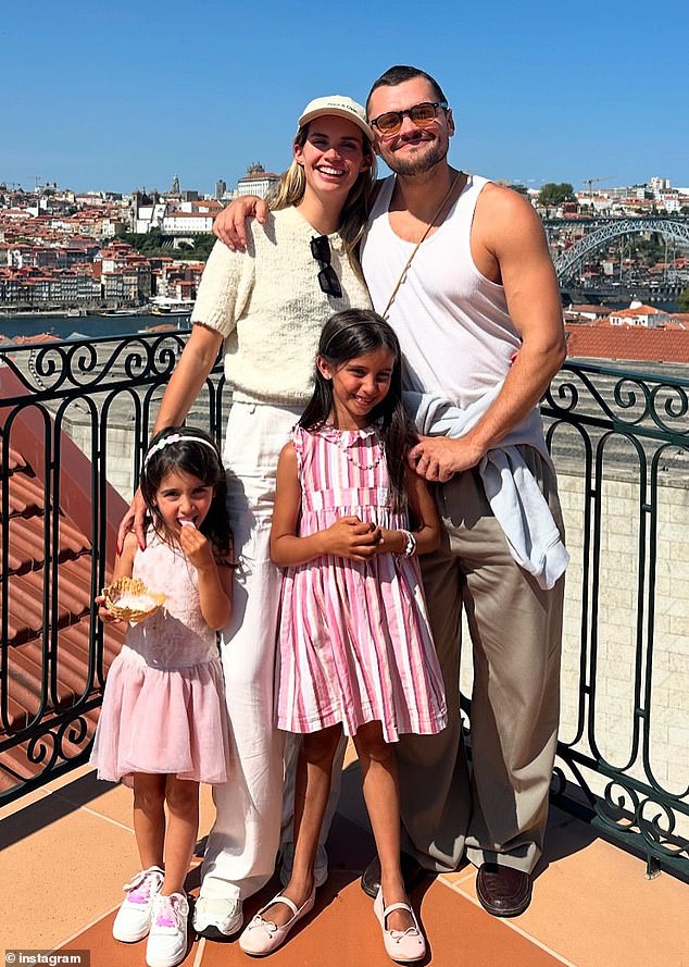 The couple posed with two adorable little girls