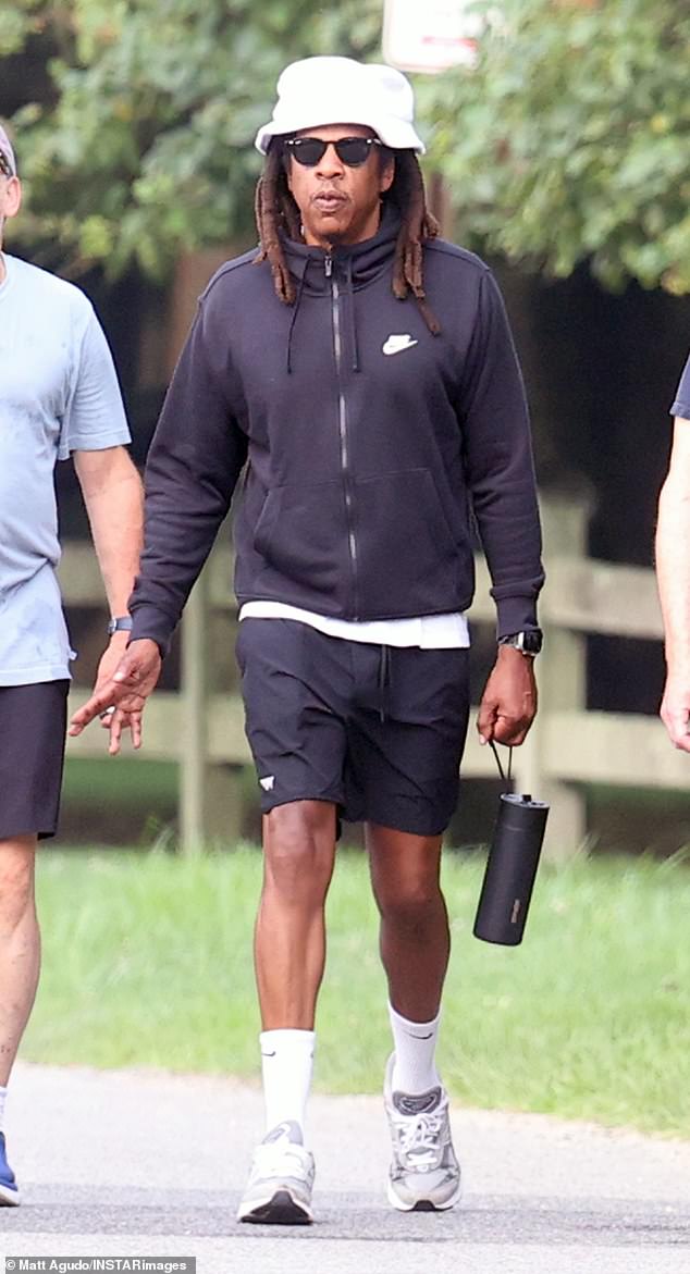 Jay-Z was spotted taking a stroll in the Hamptons on Tuesday. The 54-year-old rapper kept things casual in an all-black ensemble, paired with a white bucket hat, for his laid-back outing with friends.