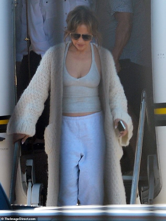 The 55-year-old star looked comfy in a low-cut gray tank top and a chunky beige knit cardigan