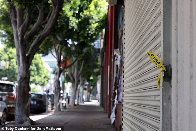 Exclusive photos from DailyMail.com also show the deserted spot where the star lost his life, with a torn piece of police tape still hanging on a heavily graffitied shop front nearby