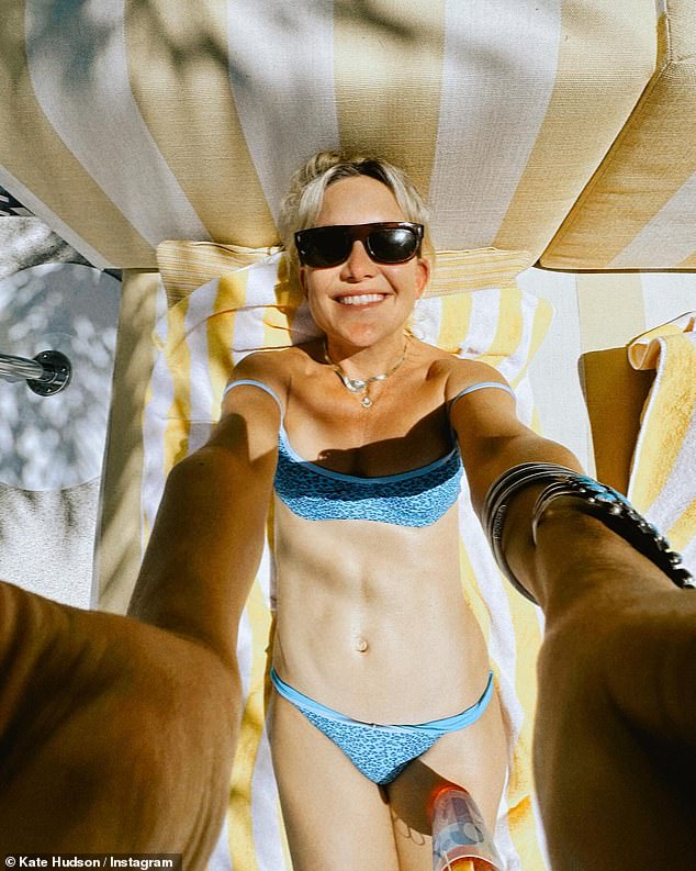 Kate Hudson, 45, showed off her washboard abs in a skimpy blue bikini as she shared racy Instagram snaps from her trip to Las Vegas on Tuesday