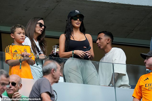 The influencer kept a modest figure and wore her long dark locks loose under a black New York Yankees baseball cap