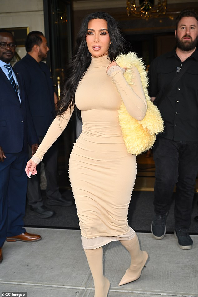 The 43-year-old billionaire wore a tight-fitting beige dress