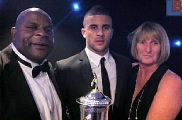 The 34-year-old professional footballer, who grew up on the Lansdowne Estate in Sheffield, told how his upbringing in social housing influenced his own parenting (pictured with his parents Michael and Tracey)