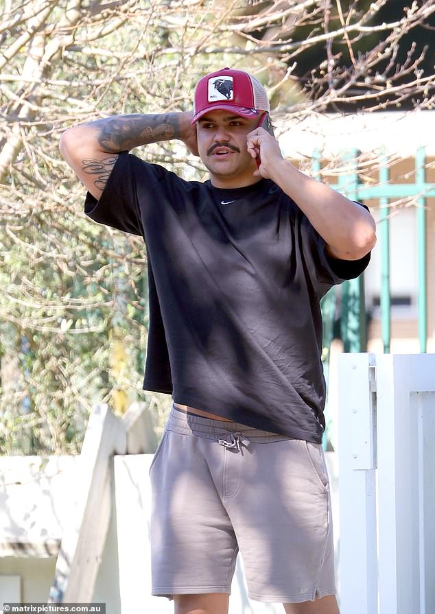 A worried-looking Latrell Mitchell stands outside his home in Sydney's south on Wednesday as the deadline to respond to the NRL's notice over his scandalous photo of the white powder approaches.