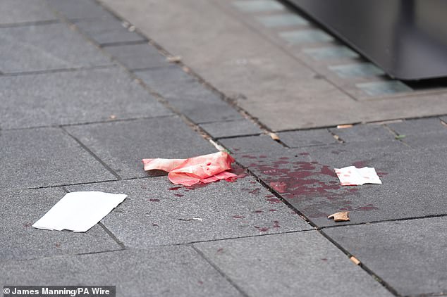 The 11-year-old NSW girl suffered injuries to her wrist, shoulder, face and neck (pictured blood on the pavement at the crime scene in Leicester Square, London)