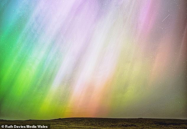 The Northern Lights and Southern Lights (auroras) are natural light displays. The displays light up when electrically charged particles from the sun enter the Earth's atmosphere. Pictured, the aurora as seen from Denbighshire, Wales, May 11, 2024