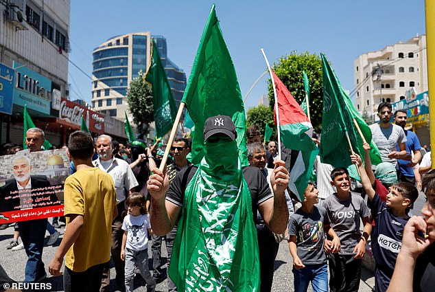 Palestinians take part in a protest after the killing of Hamas leader Ismail Haniyeh in Iran