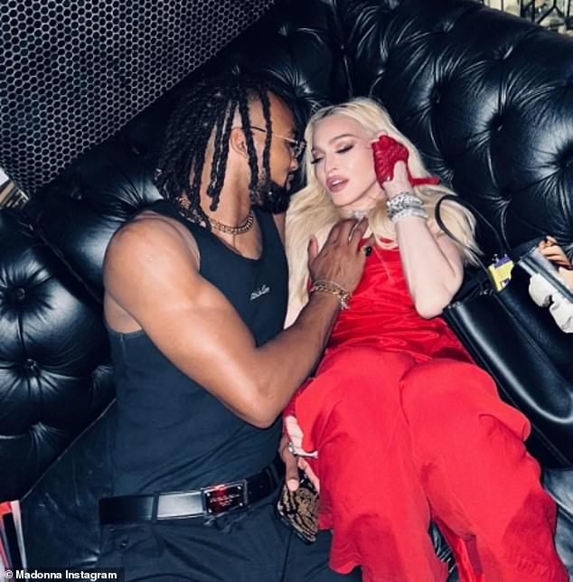 Madonna shared a racy slideshow of photos showing her and Akeem in racy poses, including one in which his hand rests on her cleavage as they lie together on a couch