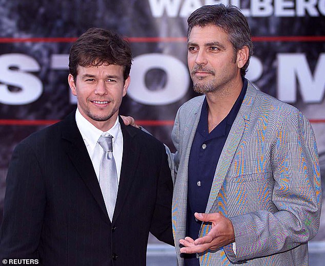 Mark Wahlberg says his mother was 'convinced' George Clooney was 'trying to hit on her' on the set of their 2000 film The Perfect Storm; the two actors are pictured at the film's UK premiere