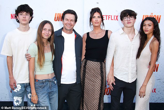 Mark Wahlberg's son Michael showed off his chest tattoo as he posed with his father Mark, 53, mother Rhea, 46, siblings Brendan Joseph, 15, Grace Margaret, 18, and girlfriend Sunni Gaines, to walk the red carpet at the premiere of The Union in Los Angeles