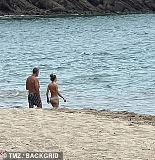 The couple was spotted walking side by side on the sand