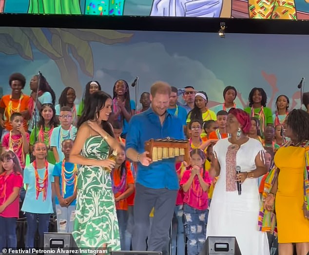 The Duke, 39, and Duchess, 43, of Sussex were cheered by a crowd during their Colombian tour as Harry was presented with a musical instrument