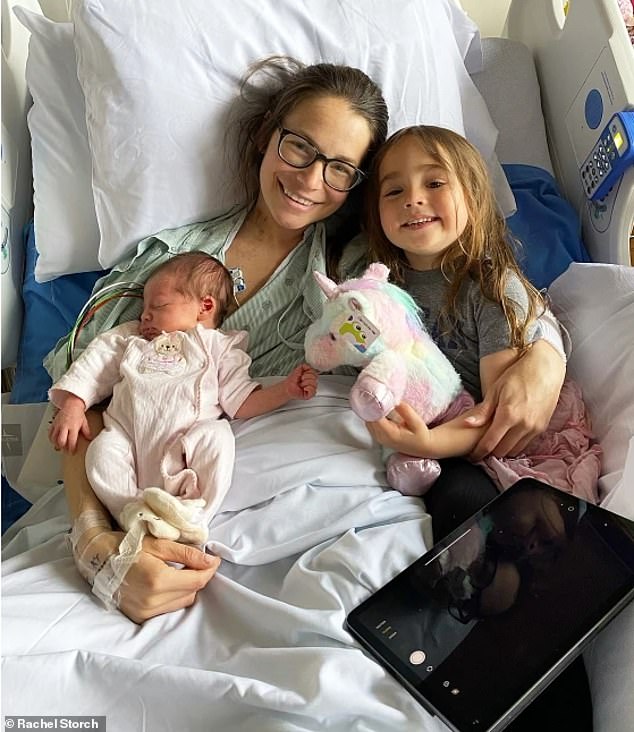 Rachel Storch, 36, gave birth to her daughter Sydney just 18 days before her surrogate gave birth to a second daughter, Remi