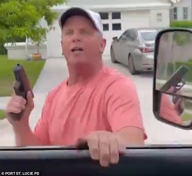 Paul Slane, 63, was caught on camera allegedly pointing a gun at an unsuspecting motorist in Port St. Lucie, Florida on Tuesday