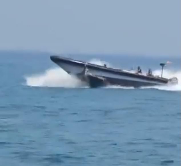 The Border Patrol's maneuver causes at least one of the small boat's occupants to fly into the air