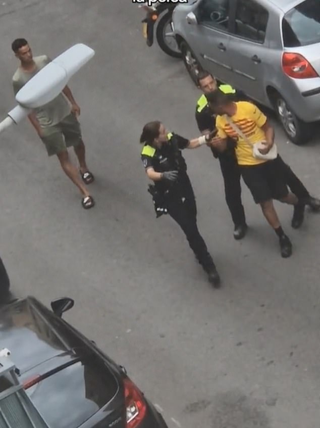 Footage has emerged of Nasraoui (yellow Barcelona shirt) being led away by police after an alleged confrontation with neighbours