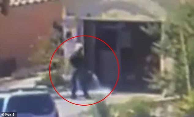 A neighbor's video captured Clark County workers clearing a man's driveway with a garden hose after he was found dead in a burning garage on June 16