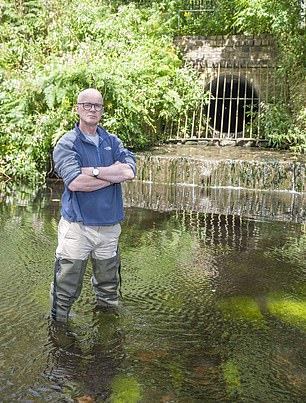 Disgraceful: Professor Jamie Woodward next to an outflow pipe on the River Tame