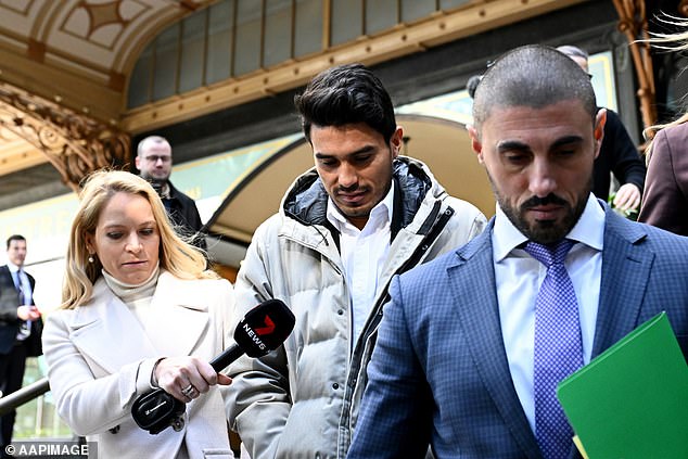 Ulises Davila, centre, leaves court at Downing Centre after being charged over alleged betting fraud