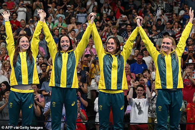 O'Callaghan (pictured left) celebrates their triumph on stage with fellow finalist teammates Lani Pallister, Brianna Throssell and Ariarne Titmus