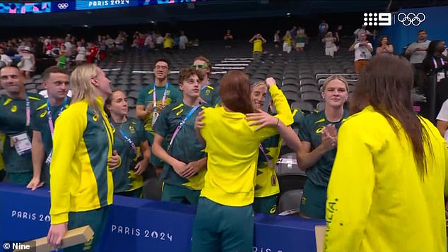 Australian swimmer Mollie O'Callaghan has hung her latest gold medal around the neck of her teammate Jamie Perkins