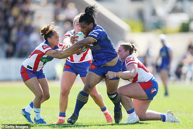 Parramatta's Elsie Albert (centre) takes the ball to Newcastle's defence during Saturday's match, which was delayed for almost 45 minutes