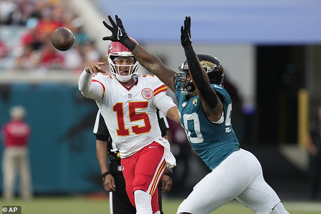 Patrick Mahomes (15) throws as Jacksonville Jaguars defensive end Trevis Gipson defends