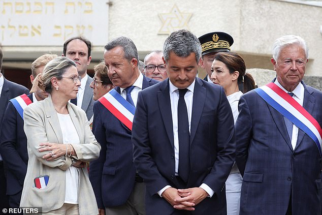 French Interior Minister Gerald Darmanin stands in front of the city's synagogue