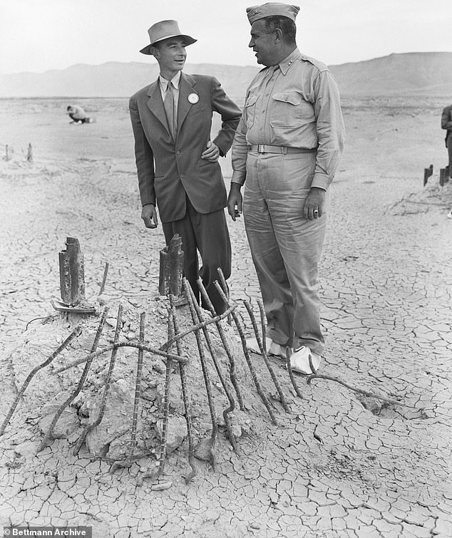 Major General Leslie Groves (right), head of the Manhattan Engineering District where the first atomic bomb was developed, and Dr. J.R. Oppenheimer, director of a top-secret project, discuss the secret program that led to the plutonium contamination that remains at the site today.